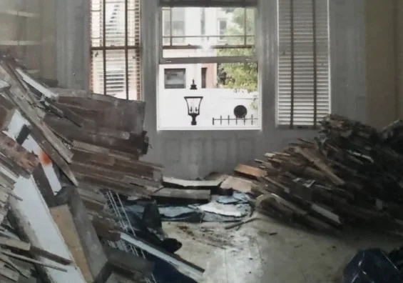 Living room before the remodel, stripped to boards and rubble