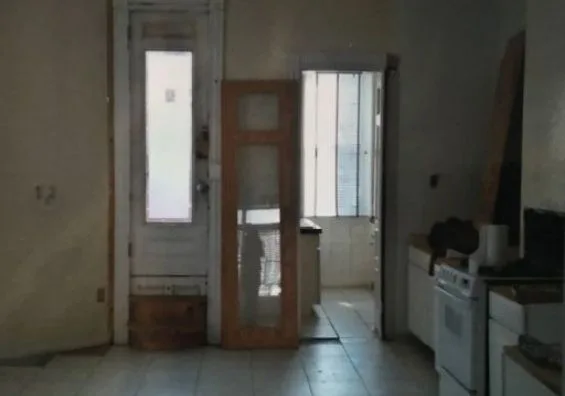 Kitchen and hall before the remodel, old doors and worn floor