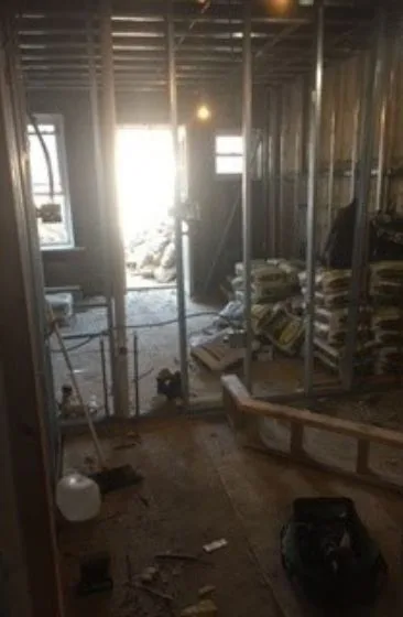 Bathroom before the remodel, open studs and debris
